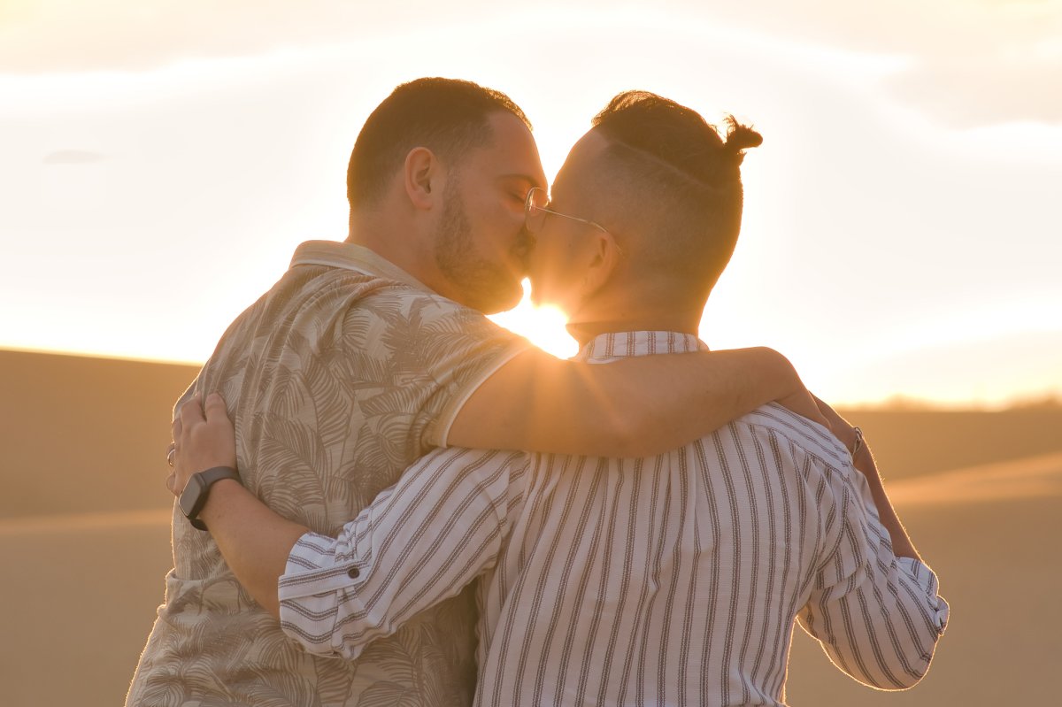 Romantic sunset – Gay couple in Maspalomas Gay couple kissing at sunset in Maspalomas dunes – romantic photoshoot